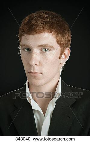 Stock Image - Young man with head turned. Fotosearch