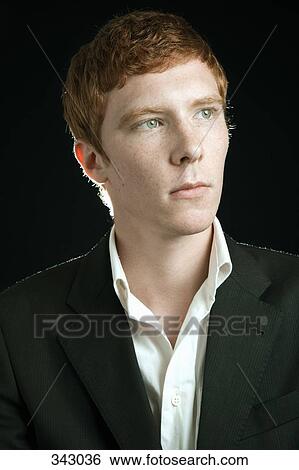 Young man with red hair looking away View Large Photo Image Stock Photograph - Young man with red hair looking away. Fotosearch