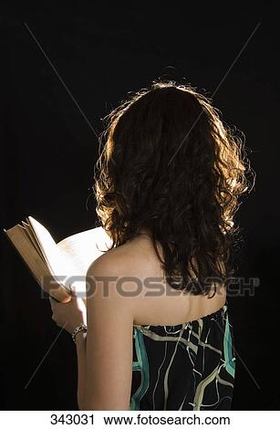 Young woman reading a book View Large Photo Image Stock Image - Young woman reading a book. Fotosearch