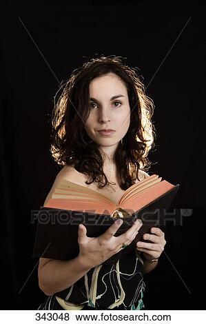 Young woman reading a book View Large Photo Image Stock Photo - Young woman reading a book. Fotosearch