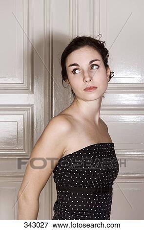 Young woman staring over her shoulder View Large Photo Image Stock Photo - Young woman staring over her shoulder. Fotosearch