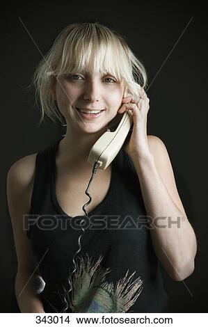 Young woman using landline telephone View Large Photo Image Picture - Young woman using landline telephone. Fotosearch