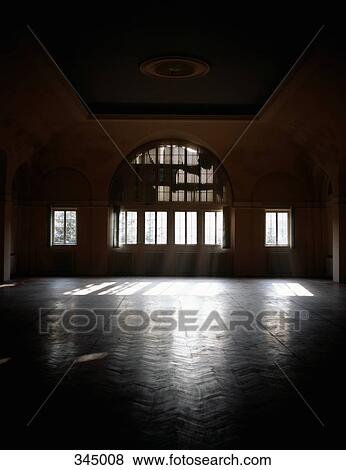 Stock Photo - Sunbeams shining in empty ballroom. Fotosearch