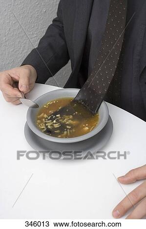 Man sitting at table with tie floating in bowl of soup View Large Photo Image Stock Image - Man sitting at table with tie floating in bowl of soup. Fotosearch