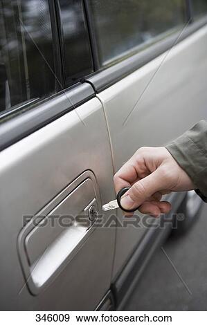 Man standing next to car with broken key in lock View Large Photo Image Stock Photo - Man standing next to car with broken key in lock. Fotosearch