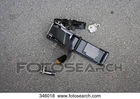 Shattered camera on asphalt View Large Photo Image Stock Photo - Shattered camera on asphalt. Fotosearch