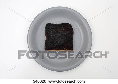Slice of burnt toast on plate View Large Photo Image Stock Photograph - Slice of burnt toast on plate. Fotosearch