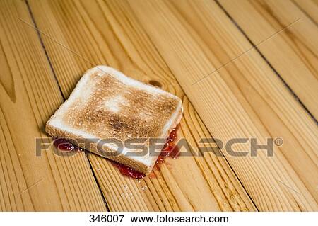 Slice of toast with strawberry jam turned upside down on floor View Large Photo Image Stock Photo - Slice of toast with strawberry jam turned upside down on floor. Fotosearch
