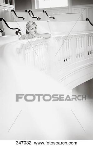 Bride sitting in church stall and resting on banister View Large Photo Image Stock Image - Bride sitting in church stall and resting on banister. Fotosearch