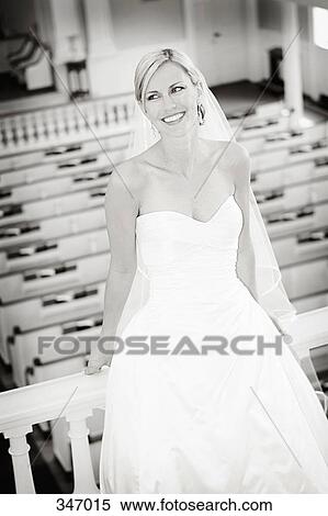 Bride sitting on railing in church stall View Large Photo Image Stock Photography - Bride sitting on railing in church stall. Fotosearch