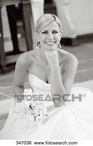 Stock Photo - Bride sitting on step at church altar. Fotosearch