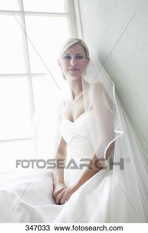 Bride sitting on window sill View Large Photo Image Stock Image - Bride sitting on window sill. Fotosearch