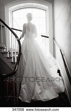 Bride standing on spiral staircase View Large Photo Image Stock Photo - Bride standing on spiral staircase. Fotosearch