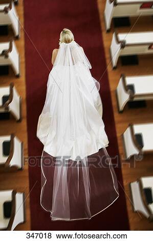 Stock Photo - Bride walking down church aisle. Fotosearch