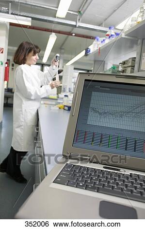 Laptop on bench and technician measuring solution with pipette in a laboratory View Large Photo Image Stock Photograph - Laptop on bench and technician measuring solution with pipette in a laboratory. Fotosearch