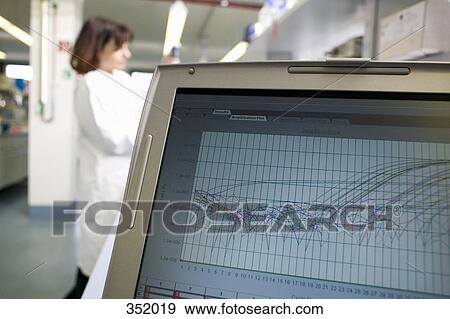 Laptop on bench and technician working in the background View Large Photo Image Stock Photo - Laptop on bench and technician working in the background. Fotosearch