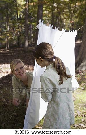 Mother playing with daughter in back yard View Large Photo Image Stock Photograph - Mother playing with daughter in back yard. Fotosearch