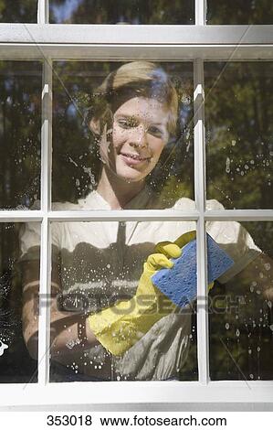 Woman cleaning inside window (view from outside) View Large Photo Image Stock Photo - Woman cleaning inside window (view from outside). Fotosearch