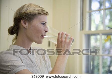 Woman drinking glass of water View Large Photo Image Stock Photo - Woman drinking glass of water. Fotosearch