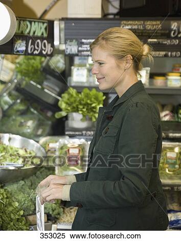 Stock Photography - Woman shopping in supermarket. Fotosearch