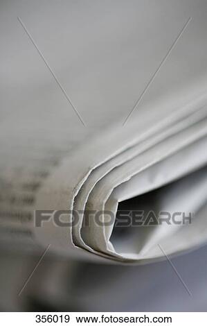 Close-up of a folded newspaper View Large Photo Image Stock Photo - Close-up of a folded newspaper. Fotosearch