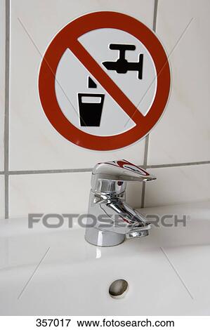 Stock Photo - ‘Do Not Drink Water’ sign above sink. Fotosearch