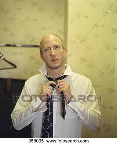 Stock Photography - Businessman getting dressed. Fotosearch