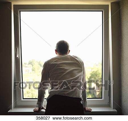 Stock Photo - Businessman looking out a window. Fotosearch