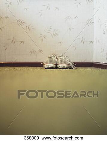 Stock Photo - Canvas sneakers in corner of room. Fotosearch