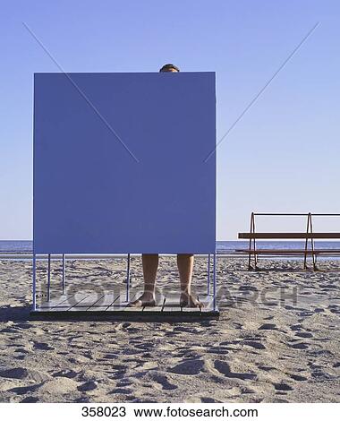 Man in a changing cubicle on a beach, Paernu, Estonia View Large Photo Image Stock Image - Man in a changing cubicle on a beach, Paernu, Estonia. Fotosearch
