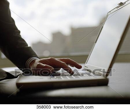 Man typing on a laptop View Large Photo Image Stock Image - Man typing on a laptop. Fotosearch