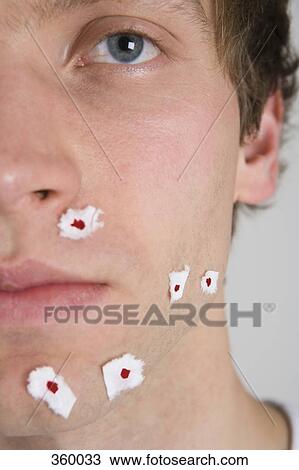 Young man with tissue paper on shaving wounds View Large Photo Image Stock Image - Young man with tissue paper on shaving wounds. Fotosearch