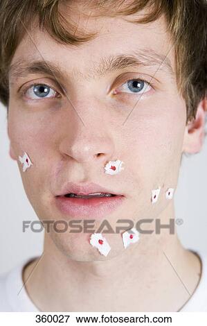 Young man with tissue paper on shaving wounds View Large Photo Image Stock Photo - Young man with tissue paper on shaving wounds. Fotosearch