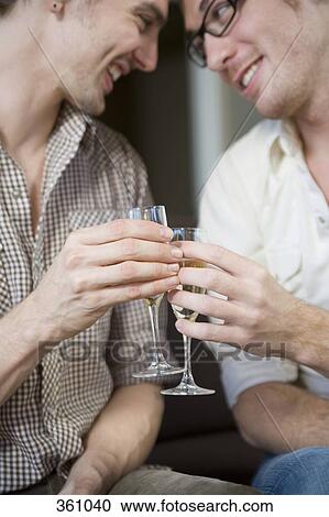 Gay couple toasting with champagne View Large Photo Image Stock Image - Gay couple toasting with champagne. Fotosearch