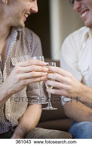 Gay couple toasting with champagne View Large Photo Image Stock Image - Gay couple toasting with champagne. Fotosearch