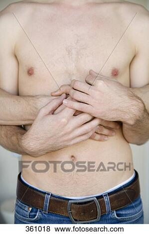 Stock Photo - Midsection view of man’s torso and his boyfriend embracing him from behind. Fotosearch