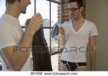 Two gay men getting dressed in morning View Large Photo Image Stock Photo - Two gay men getting dressed in morning. Fotosearch