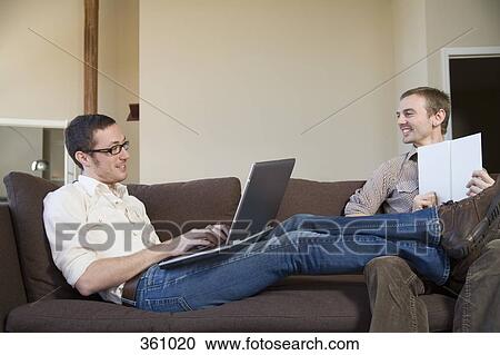 Two gay men relaxing on sofa together View Large Photo Image Stock Image - Two gay men relaxing on sofa together. Fotosearch