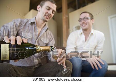 Two men drinking champagne together View Large Photo Image Stock Image - Two men drinking champagne together. Fotosearch