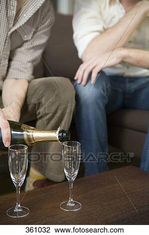Two men drinking champagne together View Large Photo Image Stock Image - Two men drinking champagne together. Fotosearch