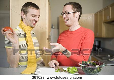 Two men preparing food in kitchen View Large Photo Image Stock Photo - Two men preparing food in kitchen. Fotosearch