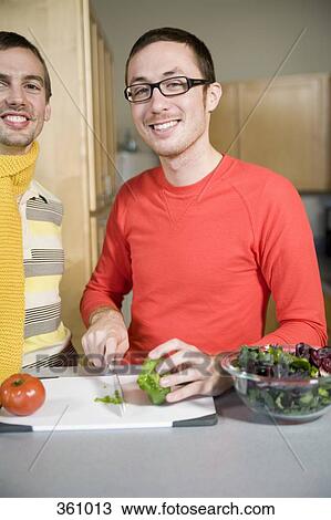 Two men preparing food in the kitchen View Large Photo Image Stock Image - Two men preparing food in the kitchen. Fotosearch