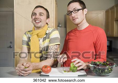 Two men preparing food in the kitchen View Large Photo Image Stock Image - Two men preparing food in the kitchen. Fotosearch