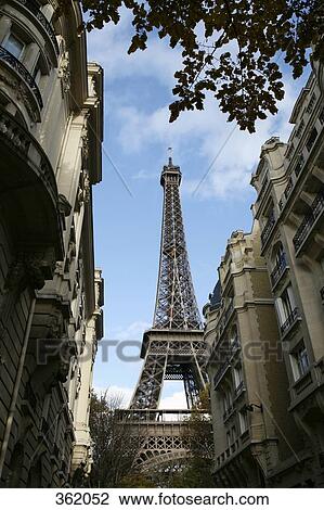 Stock Image - View of Eiffel Tower between residential buildings, Paris, France. Fotosearch