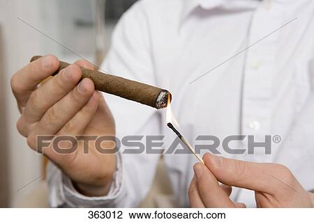 Man lighting a cigar View Large Photo Image Stock Image - Man lighting a cigar. Fotosearch