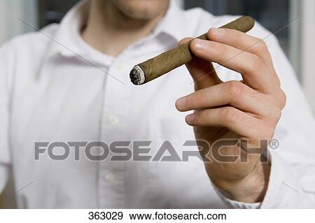 Man smoking a cigar View Large Photo Image Stock Photo - Man smoking a cigar. Fotosearch