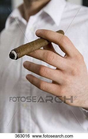 Man smoking a cigar View Large Photo Image Stock Photograph - Man smoking a cigar. Fotosearch