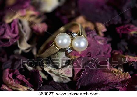 Pearl and diamond ring on potpourri View Large Photo Image Stock Photo - Pearl and diamond ring on potpourri. Fotosearch