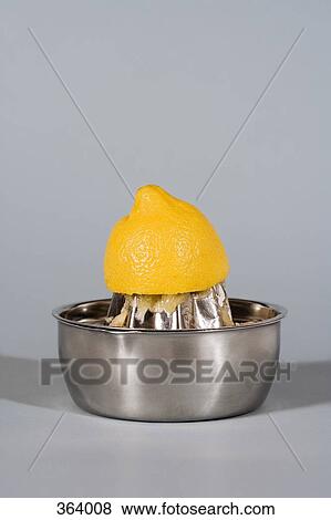 Stock Photo - Lemon half and juice squeezer. Fotosearch