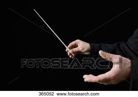 Conductor holding a baton View Large Photo Image Stock Image - Conductor holding a baton. Fotosearch